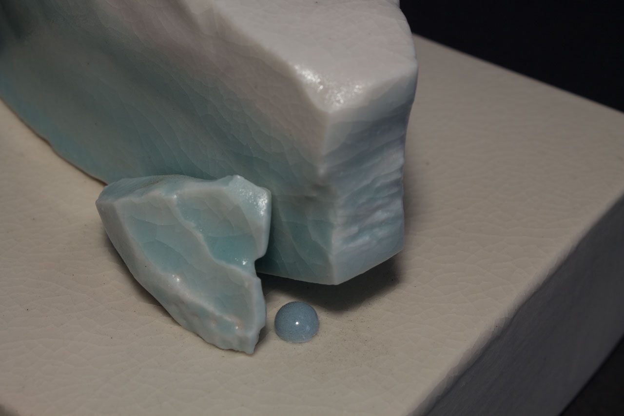 Small elegant ceramic sculpture from Mary Cay's Hope Series, #1 features a glacier with blue and white crackle glazes and a kiln-fired jewel.